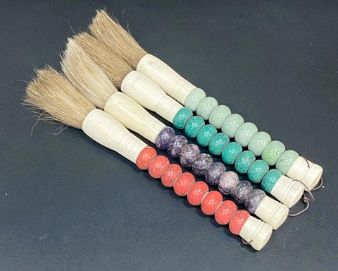 Calligraphy brush with various coloured beads